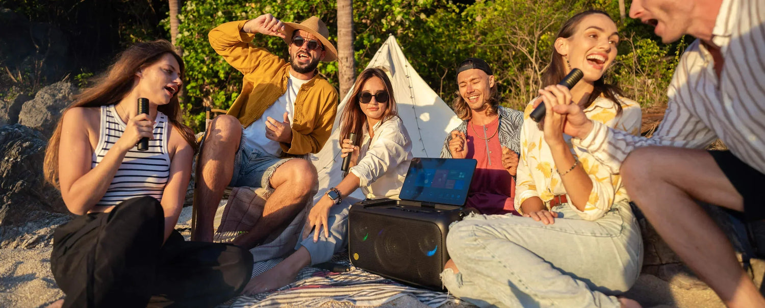 Group of friends enjoying a karaoke night at a party with a portable karaoke machine.